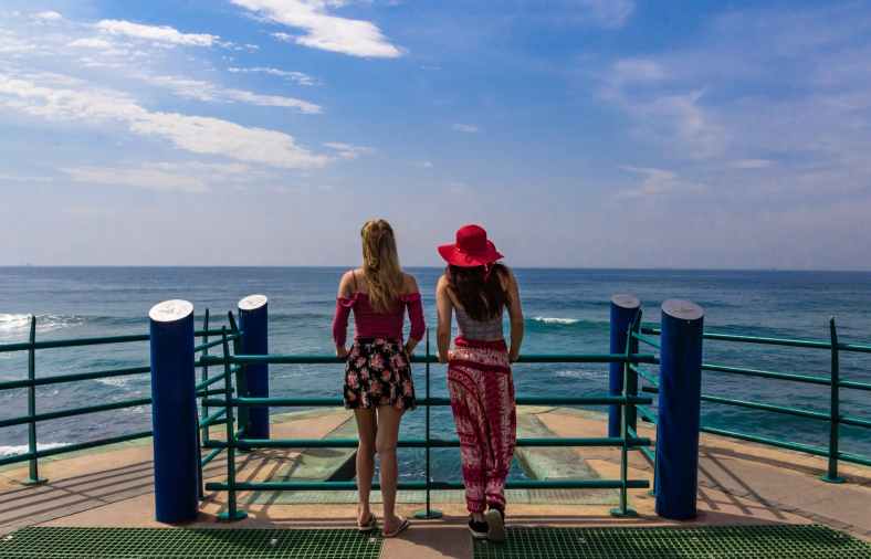 two women in boat looking at ocean